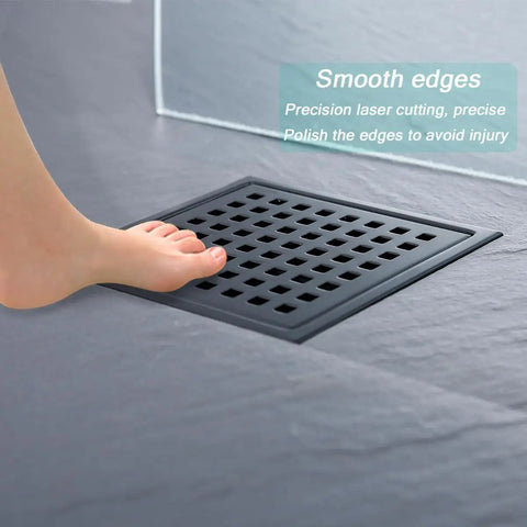 Refresh Your Shower Game With This Six Inch Square Floor Drain In Sleek Matte Black Featuring Burly 304 Stainless Steel Grid And Lightning Fast Two Inch High Flow Outlet Setup with foot on drain.