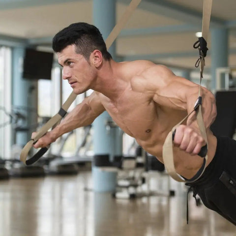 Heavy Duty Wall Mount Bracket And Ceiling Anchor Hooks For Suspension Trainer Straps in use by a muscular man in gym.