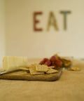 Heavy Duty Burlap Garden Fabric 12 Oz Odorless Food Grade used as a table covering under cheese, crackers, and a glass of wine.