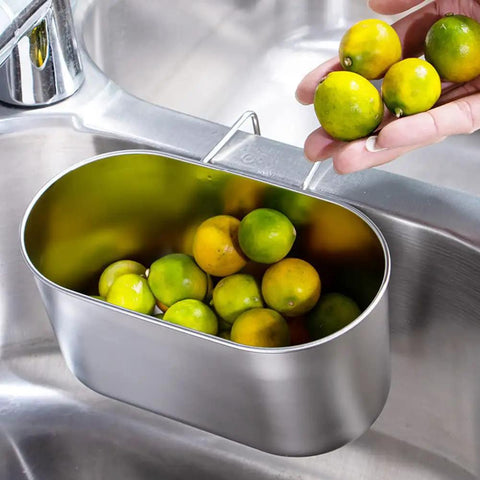 Super Solid Stainless Steel Hanging Sink Strainer Basket with limes, attached to sink, rinsing produce, silver finish.