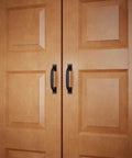 Dang Sturdy Six Inch Black Wrought Iron Cup Bin Pull Cabinet Handles on wooden cabinet doors.