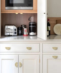 Top Shelf 10 Pack Brushed Gold Cabinet Pulls With A Slick Flat Brass Finish And Hella Sturdy Zinc Alloy Build 3 Inch Center To Center Drawer Handles installed on white kitchen cabinets.