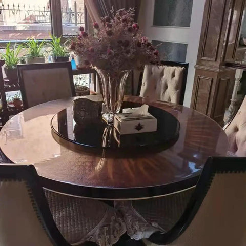 Black Tempered Glass Lazy Susan Turntable Serving Tray, 28 Inch Round Base With Heavy Duty Swivel Mechanism on dining table.