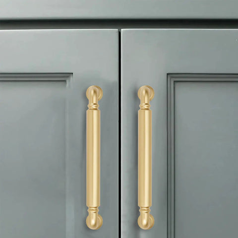 Brushed gold cabinet pulls mounted on gray cabinet doors, showcasing 10 Pack 5 Inch Hole Center Brushed Gold Cabinet Pulls Rock Solid Heavy Duty Drawer Handles Rust Proof Matte Satin Kitchen Bathroom Vanity Dresser Hardware Smooth Operation Hassle Free Setup.