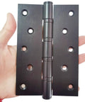 Heavy Duty Door Hinges 5 Inch Black Stainless Steel Ball Bearing Workhorse Hinges displayed in hand for installation on doors.