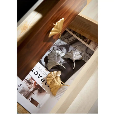 Slick Brass Cabinet Handle With Fresh Modern Nordic Vibe Sturdy Electroplated Furniture Knobs for Drawers Doors shown in a drawer.