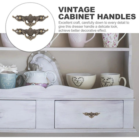 Vintage Cabinet Handles 4.33 Inch Antique Brass Drawer Pulls on white dresser with decorative cups and teapots.