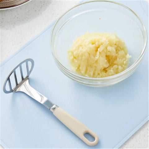 Top Rated Stainless Steel Potato Ricer And Masher Set With Sturdy Ergonomic Handles For Comfortable Handling And Quick Cleaning Perfect For Silky Baby Food And Weeknight Veggie Purees with creamy mashed potatoes in a glass bowl.