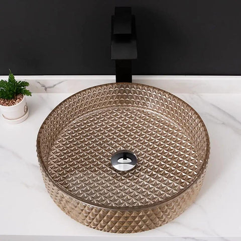 Modern Rectangular Tempered Glass Vessel Bathroom Sink Slick Finish, round basin with textured surface and sleek faucet.