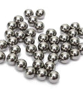 Top Tier G1000 Carbon Steel Round Balls Hefty Bulk Haul Of Five Thousand Quarter Inch precision metal shot scattered on surface.