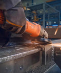 Beefed Up Brushless Angle Grinder With 125Mm Disc And 1500W Motor Variable Speed cutting metal with sparks flying in workshop.