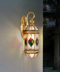 Handcrafted Stained Glass LED Wall Lantern With Copper Foil Frame Floral Hanging Porch Light For Backyard Entryway Courtyard Decor Casting Sleek Warm Ambiance Anywhere mounted on a wall with colorful floral design.