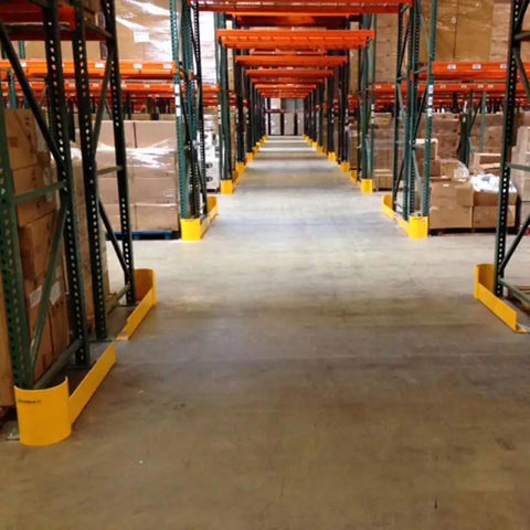 48 Inch Heavy Duty Right Hand Pallet Rack Protector Built Like A Tank Featuring Rock Hard Steel Half Moon Guard and Sloped Bracket installed in a warehouse aisle.