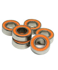 Top Shelf Hella Smooth Rolling ABEC 7 Hybrid Ceramic Ball Bearings 10 Pack 6X13X5MM stacked with orange seals for high performance skate use.