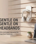 Kick Your Desk Game With 2 Adhesive Headphone Brackets on wall holding white headset, protective curved support for gaming earphones.
