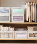 4 Pcs Foldable Closet Storage Bins With Clear Window For Slick Organization And No Sweat Folding To Keep Your Wardrobe Tidy And Make Room Organization A Total Breeze on shelves holding clothes and books.