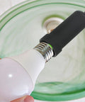 Straight Up Reliable G9 Socket Ring Wrench Kit With Sturdy Plastic T Shaped Handle For No Sweat Lamp Shade Adjustments And Quick Ceiling Fixture Repairs in use with a white light bulb and black socket.