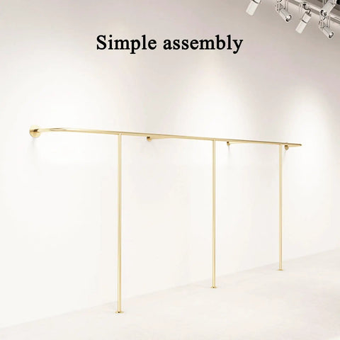 Top Tier Wall Mounted Garment Rack With Built In Shelves And Brushed Gold Finish Straight Ready For Any Boutique Or Master Closet Heavy Duty Metal Clothes Rail That Actually Holds Your Threads mounted on a white wall.