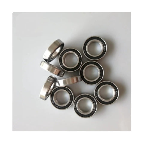 S689RS Hybrid Ceramic Ball Bearings With Stainless Steel Races and Abec 7 Precision greased, arranged on a white surface.