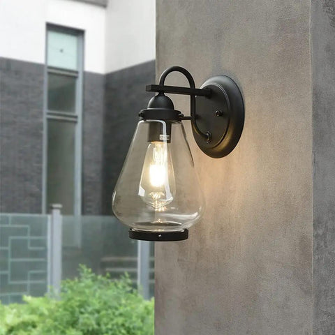 Sharp Badass Hella Waterproof Outdoor Wall Lantern With Slick Clear Glass Shade And Tough Diecast Aluminum Build For Front Porch Or Backyard Vibes Fits E27 mounted on wall.