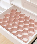 Hella Smooth Honeycomb Drawer Organizer For Closet with pink ABS plastic grid designed for sorting socks and ties.