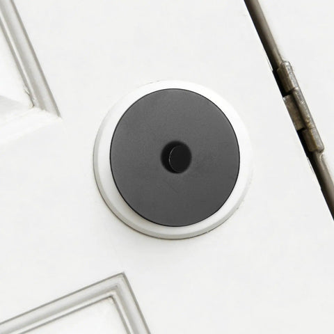 Heavy Duty Stainless Steel Decorative Deadbolt Cover Plate For Entry Doors with black round filler installed on white door.