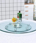 Heavy Duty Tempered Glass Lazy Susan Turntable With Large Rotating Serving Tray and 360 Degree Smooth Spin, features a glass tray with drink.