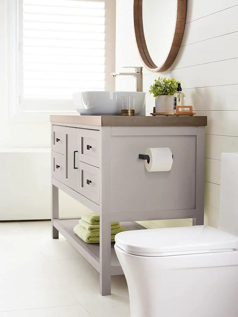 Modern bathroom setup featuring a cabinet with square matte black cabinet knobs about an inch and a quarter wide for kitchen cabinets.