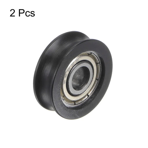 Top Shelf U Groove Pulley Set With Heavy Duty Nylon Guide Wheels For Garage Doors And Sliding Tracks Hella Durable Rubber Sealed Bearings Built Different For Sharp Turns Smooth Ride Two Pack Black, close-up of a black nylon wheel with steel bearing.