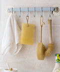 Self Adhesive Bathroom Towel Ring Holder With Rock Solid Grip Pad For Hassle Free Wall Mount Kitchen Storage Rack Stainless Steel Look hanging towels and sponges in a bathroom.