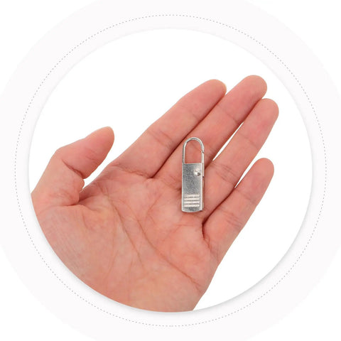 Top Shelf Universal Replacement Zipper Pull Heads 20 Piece Metal Kit With Sleek Detachable Tabs For Backpacks Purses Jackets And Luggage Repairs That Are Pure Gold, Silver metal zipper pull in hand.