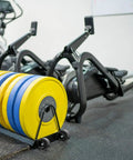 Universal Replacement Wheel Bearing Rollers For Treadmills And Exercise Bikes Heavy Duty Glide Casters, yellow and blue weights on wheels.