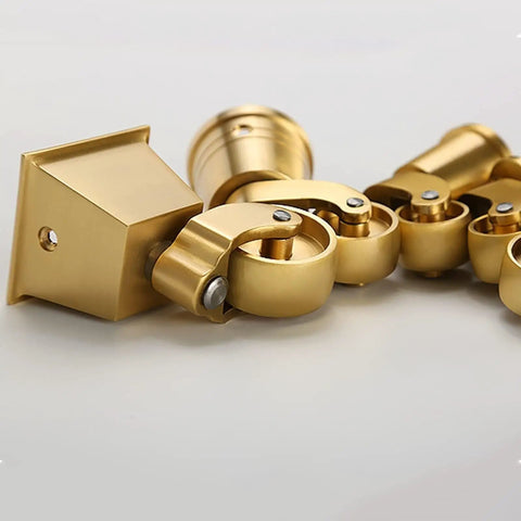 Top Shelf Solid Brass Casters Delivering Three Sixty Degree Swivel Grace For Any Couch Sofa Or Desk Antique Style Gold Cup Roller Set Of Four Built Tough And Smooth Sailing Ready, close-up view of four brass rollers.