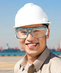 Built Heavy Duty For Real World Shop Use Ergonomic Welding Goggles With Interchangeable Lenses worn by smiling worker in hard hat outdoors.