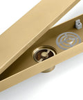 Slick Invisible Linear Shower Drain With Heavy Duty Hair Catcher Top Tier 304 Stainless Steel Bathroom Floor Channel Pure Gold Rectangular Grate showing hair catcher and brass seal.