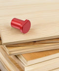 Red aluminum bench dog from Six Piece Aluminum Bench Dogs And Table Clamp Set With Low Profile Stops For Woodworking on wooden boards