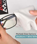 White microfiber eyeglass cleaning cloth, 20x20 cm, shown wiping a black glasses frame.