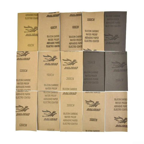 15-Piece Wet And Dry Sandpaper Set With Silicon Carbide Sheets for Metal Wood Glass and Plastic Polishing Grits 200-3000 laid out.