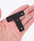 Person holding Black Stainless Steel T Shape Flat Angle Brackets With Countersunk Screw Holes For Chairs And Tables