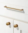 10 Pack 3 Inch Antique Brass Cabinet Pulls Swanky Bin Cup Drawer Handles shown on white cabinet doors