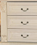 Straight Up Vintage Antique Bronze Drop Bail Pulls With Slick Carved Texture on white dresser drawers.