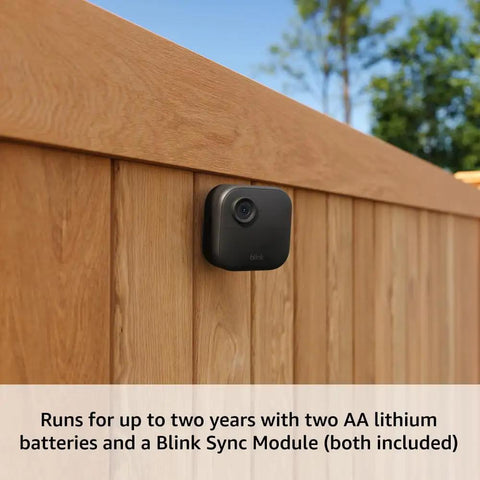Guard Your Property With Zero Hassle Using This Five Camera Wirefree Home Security Kit That Delivers Hella Sharp 2K Doorbell Footage Quick Sync Module Hookup And Two Year Battery Life Modern Black mounted camera on a wooden fence.