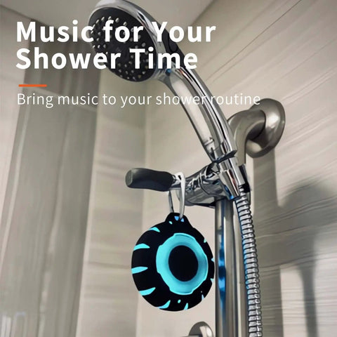 Waterproof Shower Bluetooth Speaker with IPX7 Rating hanging on showerhead, ultra portable carabiner clip, crisp clear sound.