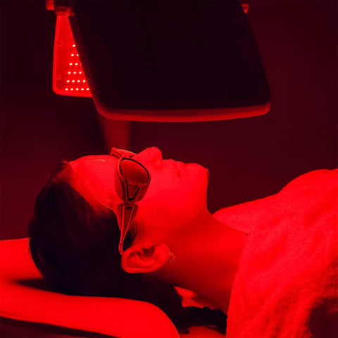 High End Red Light Therapy Goggles for Laser and Infrared Eye Safety with Side Shields and Brow Cover to Block LED Radiation and Keep Your Peepers Fresh so That Healthy Glow Vibe Keeps Rolling worn during a red light therapy session.