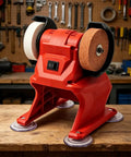 Badass Performance Compact 21V Cordless Bench Grinder With Coarse Plus Fine Dual Wheels, red, on workbench with tools in background.