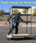 Person pushing metal shelving on wheels outdoors