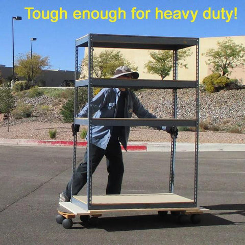 Person pushing metal shelving on wheels outdoors