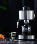 Solid No Fuss Compact Fully Automatic Bean To Cup Coffee Maker Black One Touch Grinding Machine on dark surface with cup and croissant.