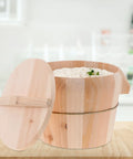 Hand Finished Wooden Rice Steamer Bucket, Detachable Anti Scald Rice Pot With Comfortable Grip Lid, filled with rice on counter.