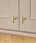 Thirty Hella Sturdy Brushed Brass Cabinet Knobs Featuring Slick Two Inch Square Bar Hardware installed on kitchen cabinets.